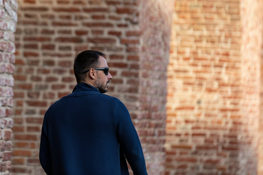 Man in his fifties with short graying hair in a navy sweater