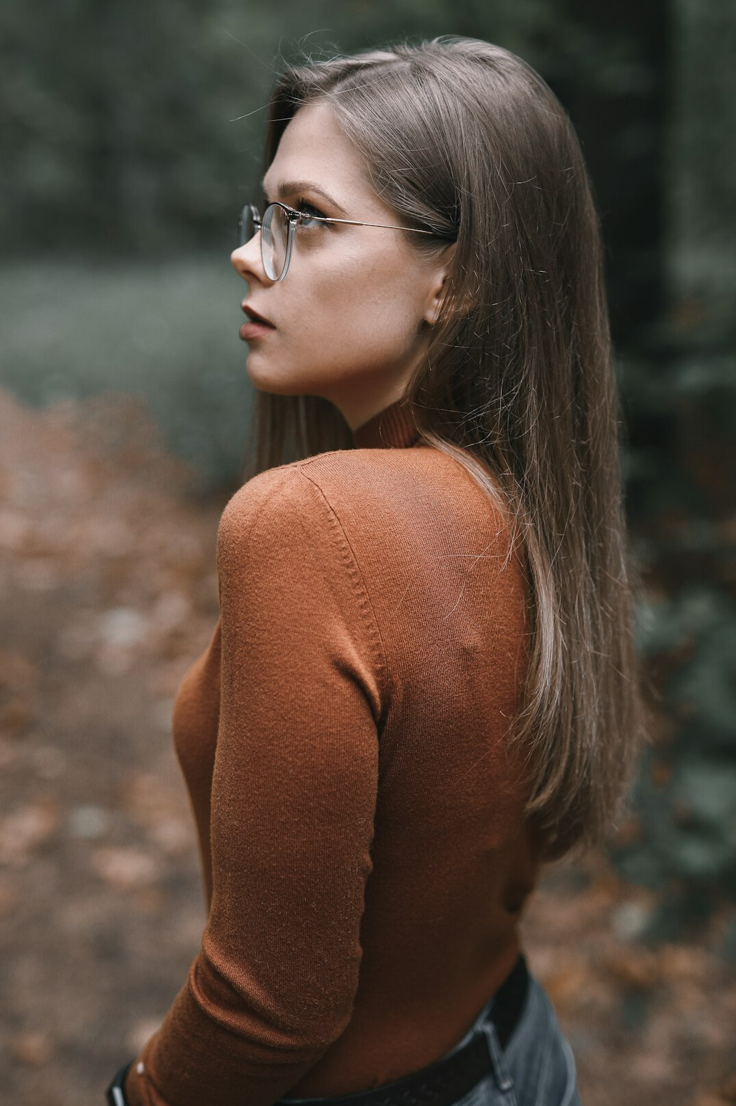 Woman in her fifties with shoulder length brown hair and glasses